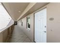 A clean hallway with tiled floors and a white door at 5200 Brittany S Dr # 1708, St Petersburg, FL 33715