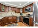 Modern kitchen with stainless steel appliances and wood cabinets at 5200 Brittany S Dr # 1708, St Petersburg, FL 33715