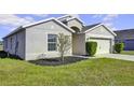 House exterior with neutral paint, two-car garage, and landscaping at 6731 Wirevine Dr, Brooksville, FL 34602