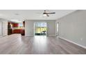 Spacious living room with vinyl plank flooring and access to the back patio at 6731 Wirevine Dr, Brooksville, FL 34602