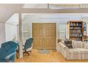 Living room with double doors, built-in shelving, and comfy seating at 7923 18Th E Ave, Palmetto, FL 34221