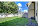 Exterior yard with mature trees and grass at 10100 Sailwinds N Blvd # 106, Largo, FL 33773