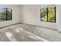 Spacious bedroom with neutral carpeting and large windows at 1127 Pine Ridge W Cir # A2, Tarpon Springs, FL 34688