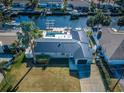 Bird's-eye view of a waterfront home showcasing its unique layout and canal access at 1332 47Th Ne Ave, St Petersburg, FL 33703