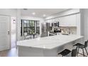 Modern kitchen with white cabinets, stainless steel appliances, and quartz countertops at 2582 Bentley Dr, Palm Harbor, FL 34684