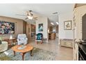 Bright living room with hardwood floors, comfy seating, and views into kitchen at 37538 Corey Lewis Ave, Zephyrhills, FL 33541