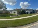 One-story house with a palm tree and well-maintained landscaping at 4611 Horseshoe Pick Ln, Valrico, FL 33594