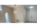 Bright and airy living room with high ceilings, neutral walls, and wood-look flooring at 4611 Horseshoe Pick Ln, Valrico, FL 33594