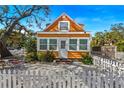 Charming yellow cottage with white picket fence and mature tree at 5407 29Th S Ave, Gulfport, FL 33707