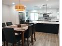 Modern kitchen with island, stainless appliances, and dark cabinets at 624 Almeda N Ct, St Petersburg, FL 33702