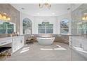 Luxurious bathroom features a freestanding tub, dual vanities, and large windows at 3073 Woodsong Ln, Clearwater, FL 33761