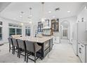Gourmet kitchen boasts modern appliances and spacious island with seating at 3073 Woodsong Ln, Clearwater, FL 33761