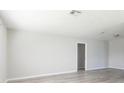 Bright, open living room with neutral walls, and wood-look laminate flooring offers a modern feel at 6701 13Th N Ave, St Petersburg, FL 33710