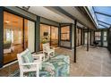 Relaxing screened porch with patio furniture and view of backyard at 943 Lucas Ln, Oldsmar, FL 34677