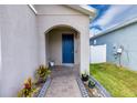 Front entrance with blue door and brick walkway at 11834 Brighton Knoll Loop, Riverview, FL 33579