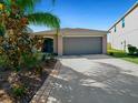 Beautiful single-story home with a well-maintained lawn and two-car garage at 16912 Yellow Pine St, Wimauma, FL 33598
