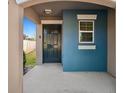 Welcoming front porch featuring a dark front door and blue accent wall at 16912 Yellow Pine St, Wimauma, FL 33598