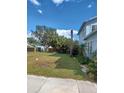 View of the side yard with unkempt grass at 1905 And 1907 N Armenia Ave, Tampa, FL 33607