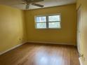Bright bedroom with hardwood floors and double windows at 820 Virginia St # 207, Dunedin, FL 34698