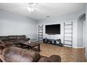 Spacious living room featuring a large TV, comfortable seating, and built-in shelving at 10836 Standing Stone Dr, Wimauma, FL 33598