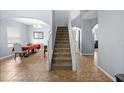 Elegant entryway with a grand staircase at 10836 Standing Stone Dr, Wimauma, FL 33598