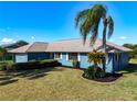 Landscaped yard and a blue home exterior at 1715 S Pebble Beach Blvd, Sun City Center, FL 33573