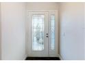 Elegant front door featuring decorative glass panel and side window, welcoming guests with style at 1715 S Pebble Beach Blvd, Sun City Center, FL 33573