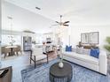 Bright, open-concept living room showcases modern decor and seamless flow to the kitchen and dining areas at 1715 S Pebble Beach Blvd, Sun City Center, FL 33573
