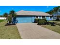 Front view of a home with a two-car garage at 1715 S Pebble Beach Blvd, Sun City Center, FL 33573