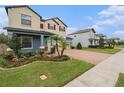 Two-story house with a three-car garage, palm trees, and a landscaped yard at 2999 Hilliard Dr, Wesley Chapel, FL 33543