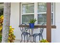 Small front porch with bistro table and chairs, offering a relaxing outdoor space at 3401 W North B St, Tampa, FL 33609