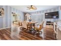 Bright dining area with hardwood floors and a charming wooden table set at 37635 Gill Ave, Zephyrhills, FL 33541