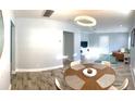Modern dining area with a wood table and chairs, opening to living room at 1114 Palm Bluff St, Clearwater, FL 33755