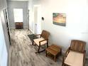 Spacious hallway with tile flooring, coat rack, and comfortable seating area at 1114 Palm Bluff St, Clearwater, FL 33755