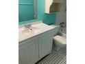 Bathroom with white vanity and teal walls at 1125 83Rd N Ave # A, St Petersburg, FL 33702