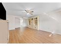 Bright living room with laminate floors and built-in shelving at 1950 59Th N Ave # 114, St Petersburg, FL 33714