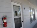 Front door of an apartment unit with a fire extinguisher at 2100 World Parkway Blvd # 58, Clearwater, FL 33763