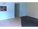 Bright living room with tile flooring that flows into the kitchen through a convenient serving window at 2462 Brazilia Dr # 20, Clearwater, FL 33763