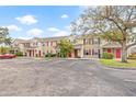 Row of tan two story townhouses with red accents at 4850 51St W St # 3105, Bradenton, FL 34210