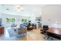 Open concept living room with modern furniture, a home office space, and a view into the kitchen at 540 Rose Apple Cir, Port Charlotte, FL 33954
