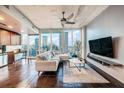Modern living room with city views, dark tile floors, and comfy seating at 777 N Ashley Dr # 1808, Tampa, FL 33602