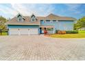 Three-car garage and brick paver driveway at 1135 Candler Rd, Clearwater, FL 33765