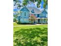 Two-story blue house with a large front yard at 1135 Candler Rd, Clearwater, FL 33765