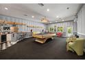 Spacious game room features a full wet bar, pool table, and lively decor at 2501 Rustic Oaks Dr, Lutz, FL 33559