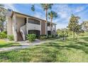 Two-story building with landscaped grounds at 3020 Bonaventure Cir # 102, Palm Harbor, FL 34684