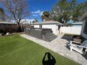 Backyard oasis with hot tub, patio, and artificial turf at 507 79Th Ave, St Pete Beach, FL 33706