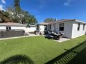 Artificial turf backyard with patio furniture and a hot tub at 507 79Th Ave, St Pete Beach, FL 33706