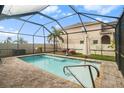 Relaxing screened-in pool area with patio furniture and a spacious deck at 10236 Newminster Loop, Ruskin, FL 33573