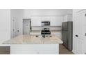 Modern kitchen with granite island and stainless steel appliances at 29658 Fedora Cir, Brooksville, FL 34602