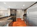 Modern kitchen featuring stainless steel appliances, granite countertops, and ample cabinet space at 345 Bayshore Blvd # 308, Tampa, FL 33606